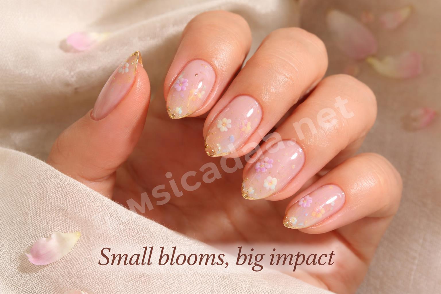 Closeup gold french tip nails with pastel flowers